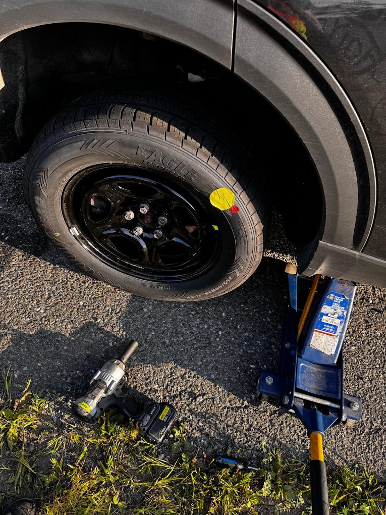 Roadsides Finest technician changing a flat tire in Toronto